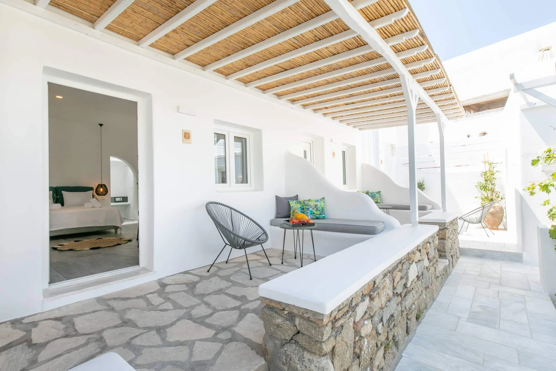 Reed-covered terrace with stone wall and seating